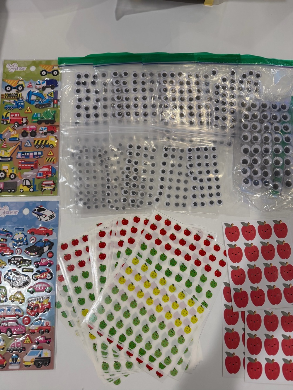 Bundle of back to school apple stickers, googly eyes, & transportation sticker